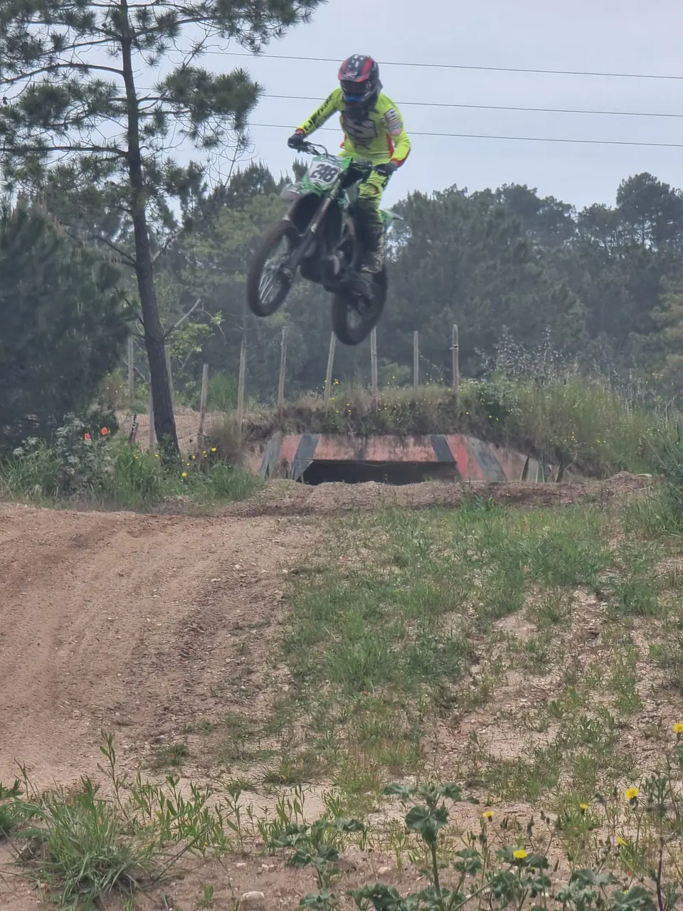 Piloto em salto numa pista de motocross